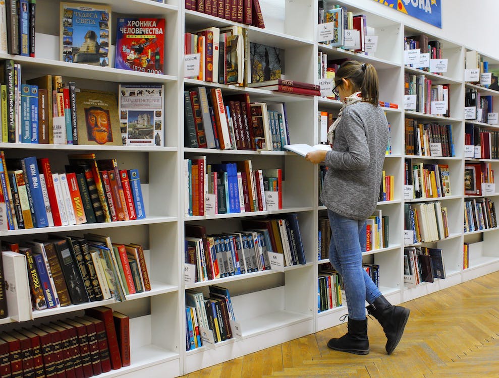 girl at library looking at books